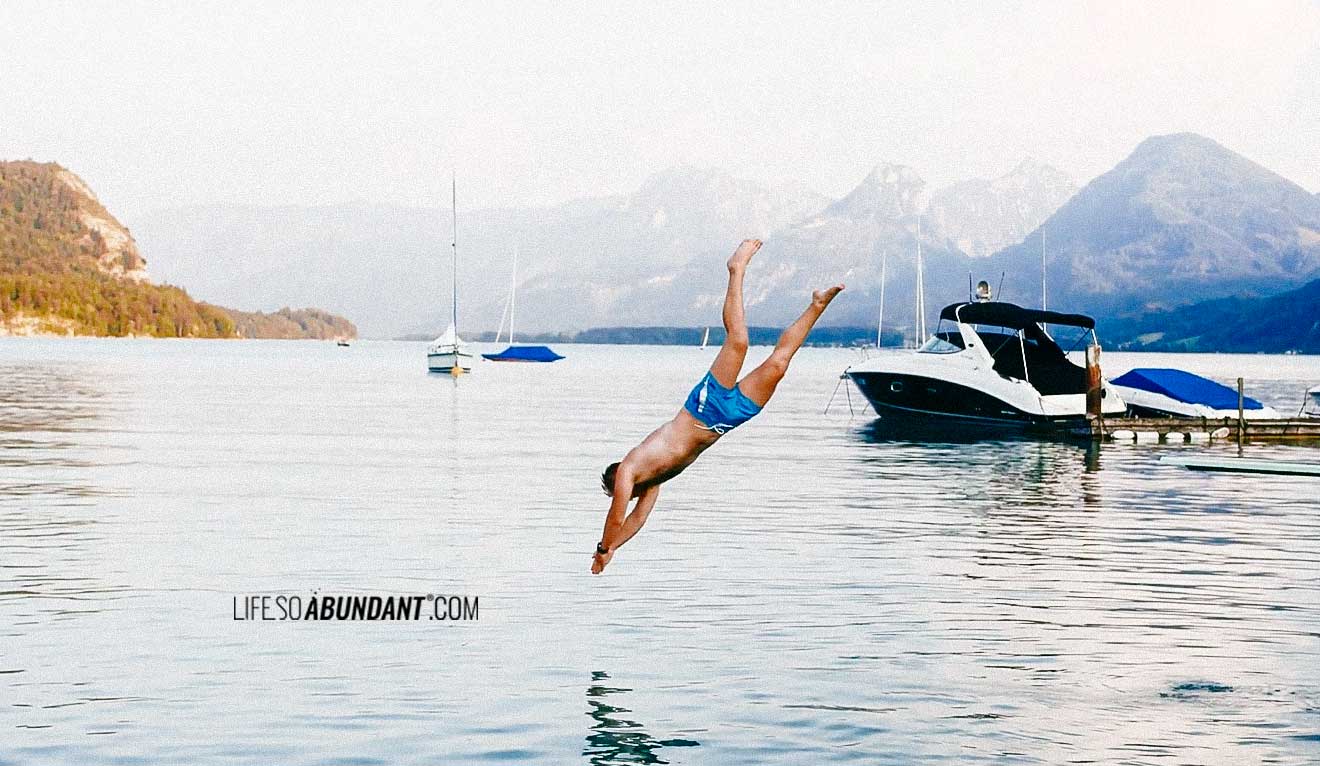 Young Man Jumping Into the Water from Diving Board - Life So Abundant®