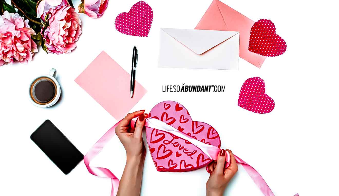 Valentines Gift Basket Ideas - Female Hands Assembling Valentine Gift Items - Life So Abundant®